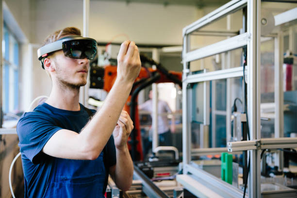 industry 4.0: Young engineer works with a head-mounted display