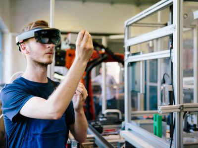 industry 4.0: Young engineer works with a head-mounted display
